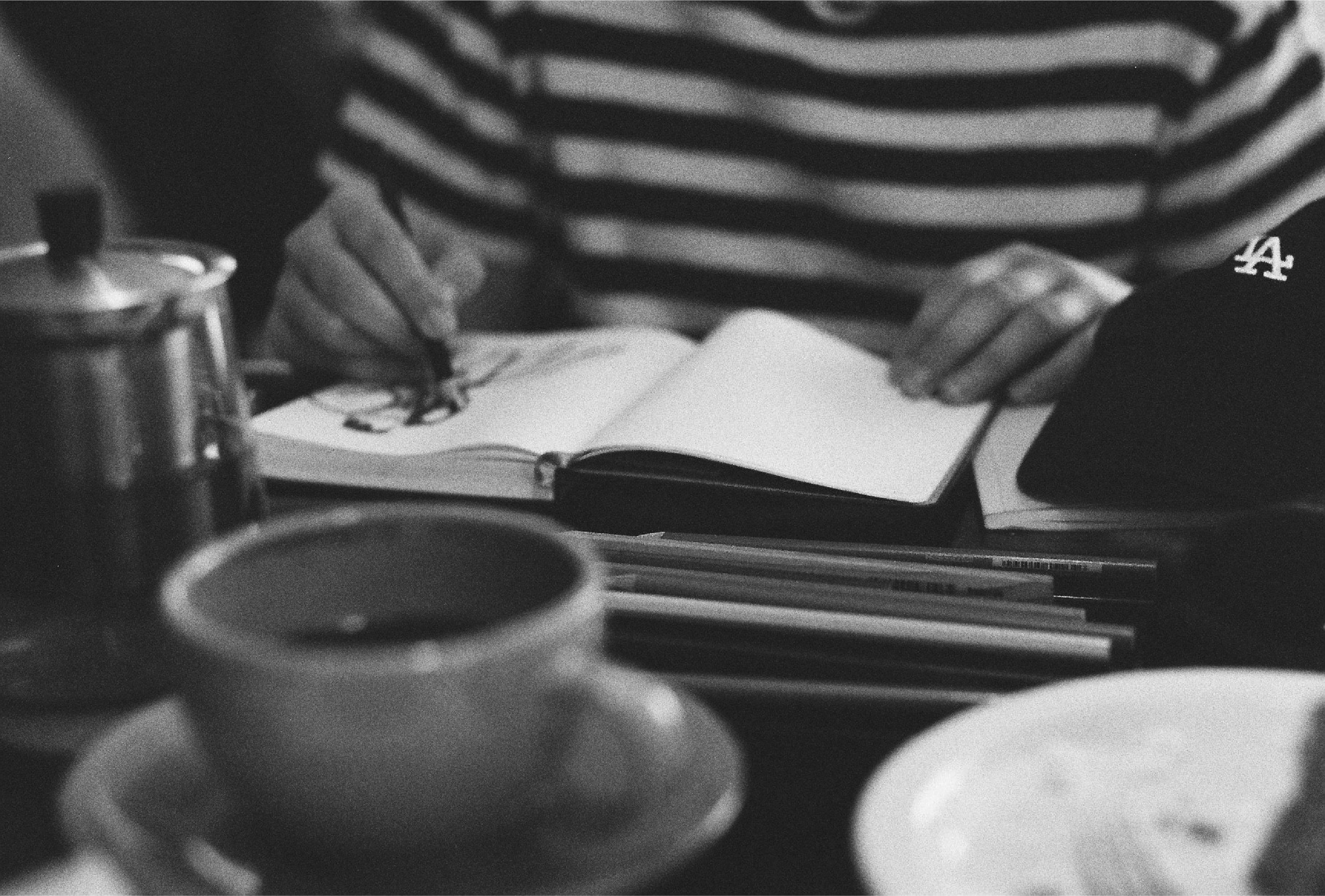 person writing on white paper