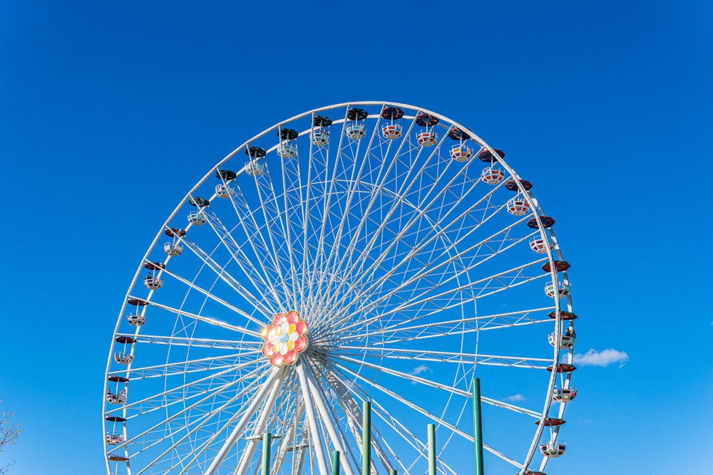 white and red ferris wheel under blue sky during daytime