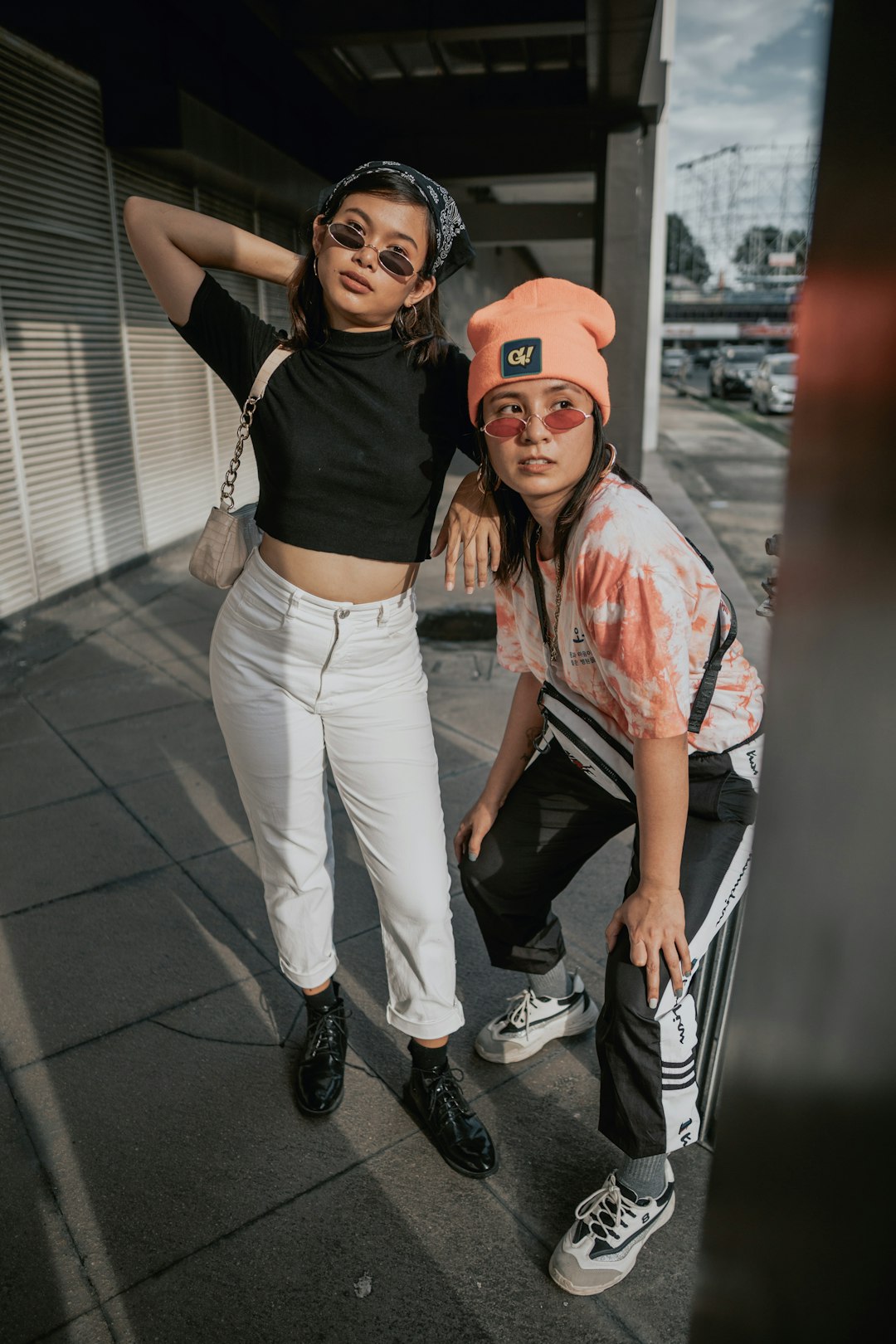 man in black tank top and white pants beside woman in white pants