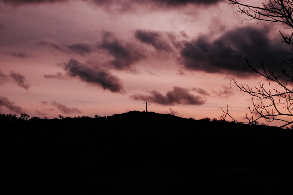 silhouette of wind turbines during sunset