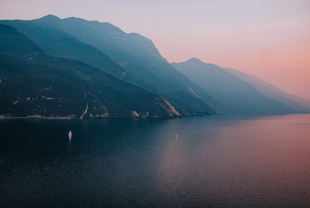 body of water between mountains during daytime