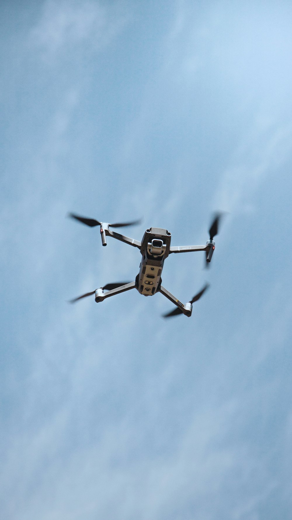 black and yellow drone flying in the sky