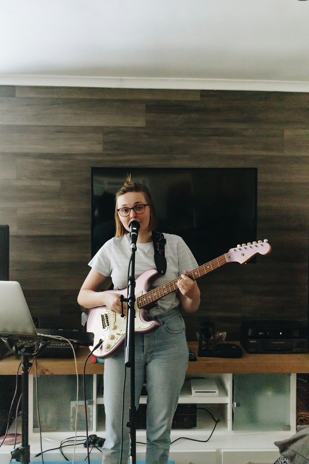 man in blue denim button up shirt playing guitar