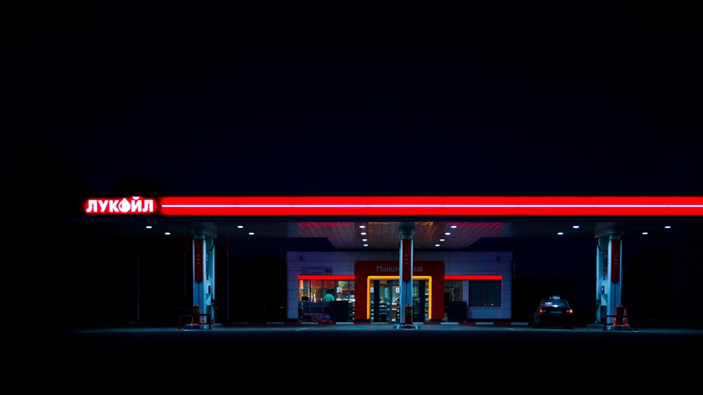 red and white store during night time