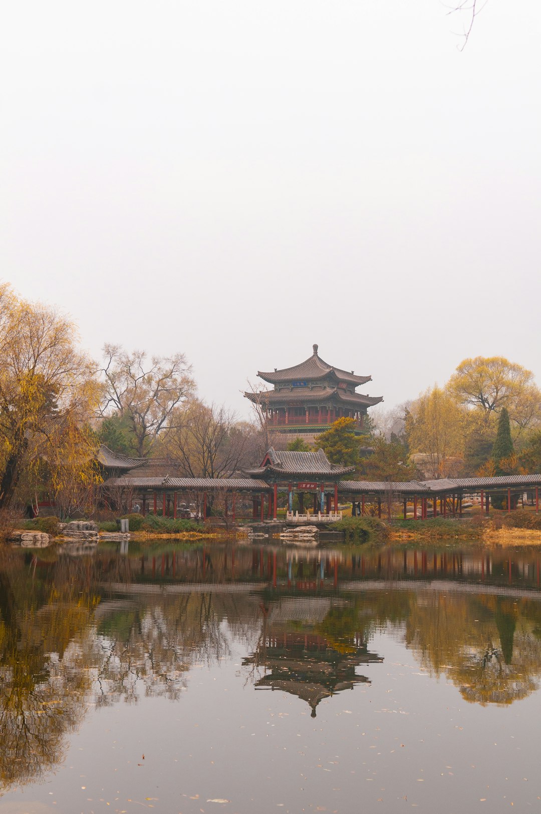 brown and black temple near lake during daytime