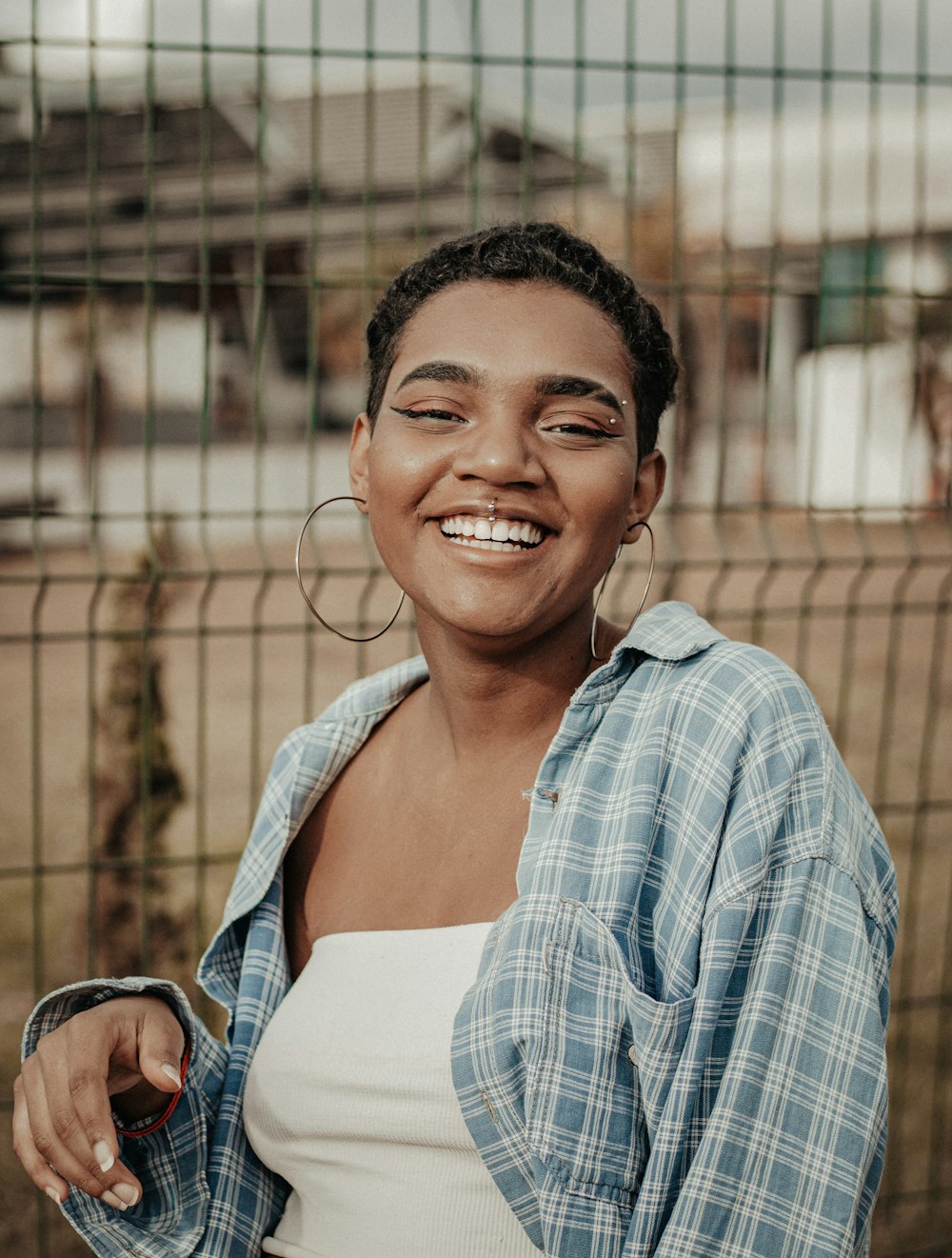 smiling woman in blue and white plaid dress shirt