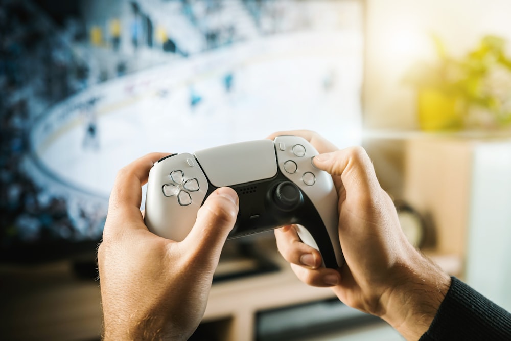 person holding black game controller