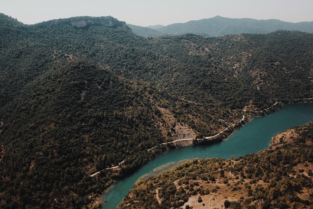 green lake between mountains during daytime