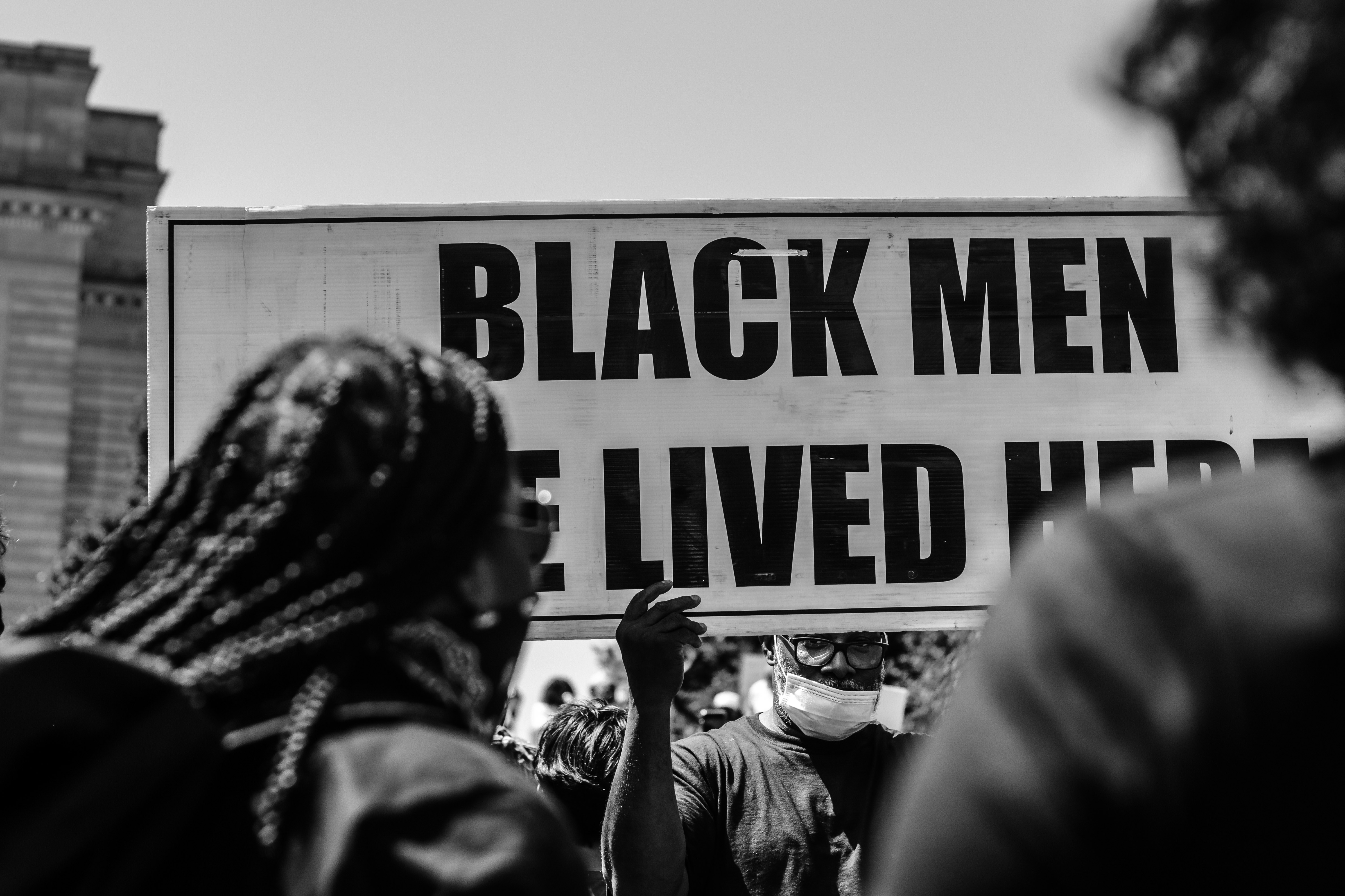 Grayscale photo of people holding a signage photo – Free Grey Image on ...
