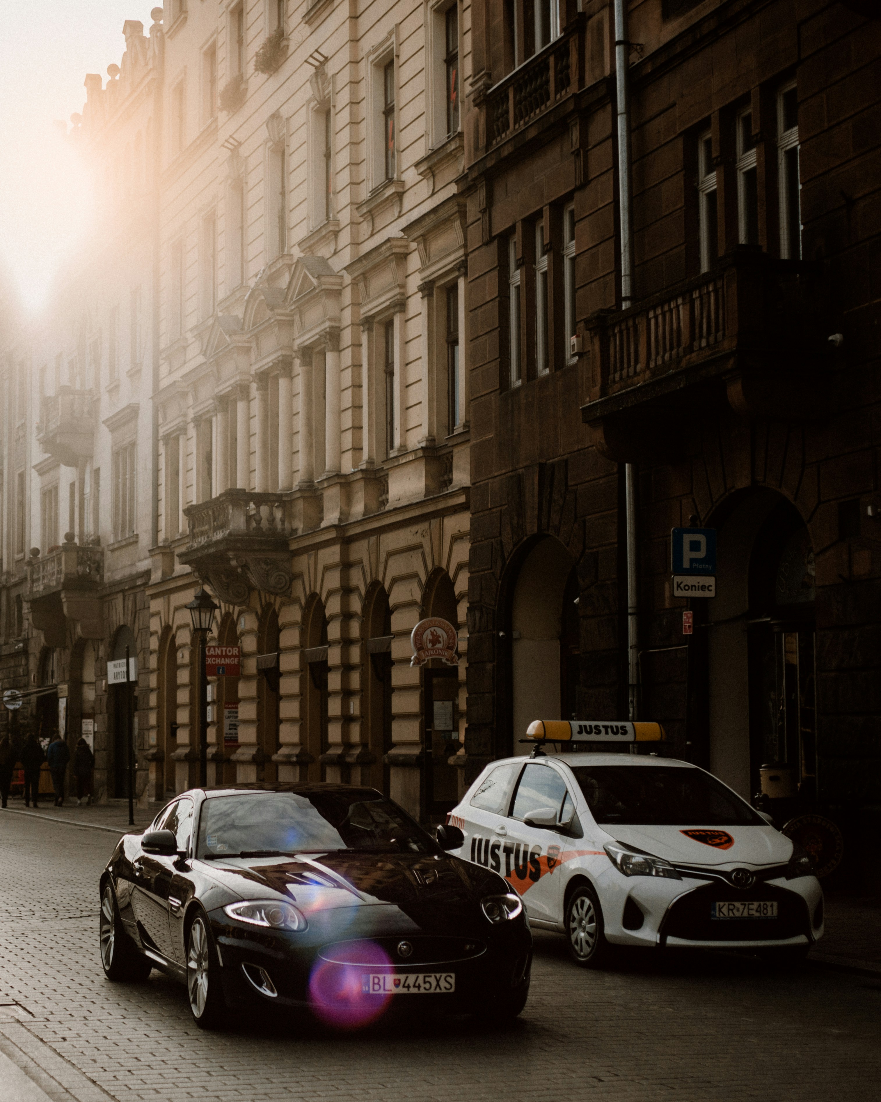 purple and white cars on road near buildings during daytime