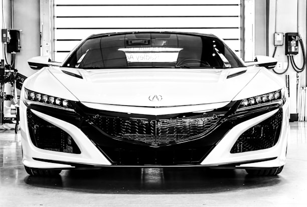A sleek sports car parked in a modern garage, showcasing its polished exterior and powerful design.