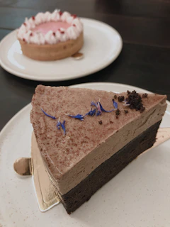 Close-up of a beautifully decorated chocolate mousse cake with delicate edible flowers