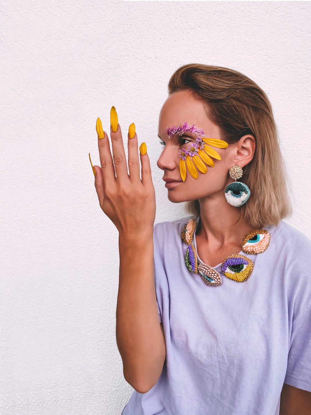 girl in white shirt with blue and yellow hair tie