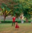 Smiling toddler wearing a colorful boutique dress, playing in a sunlit park.