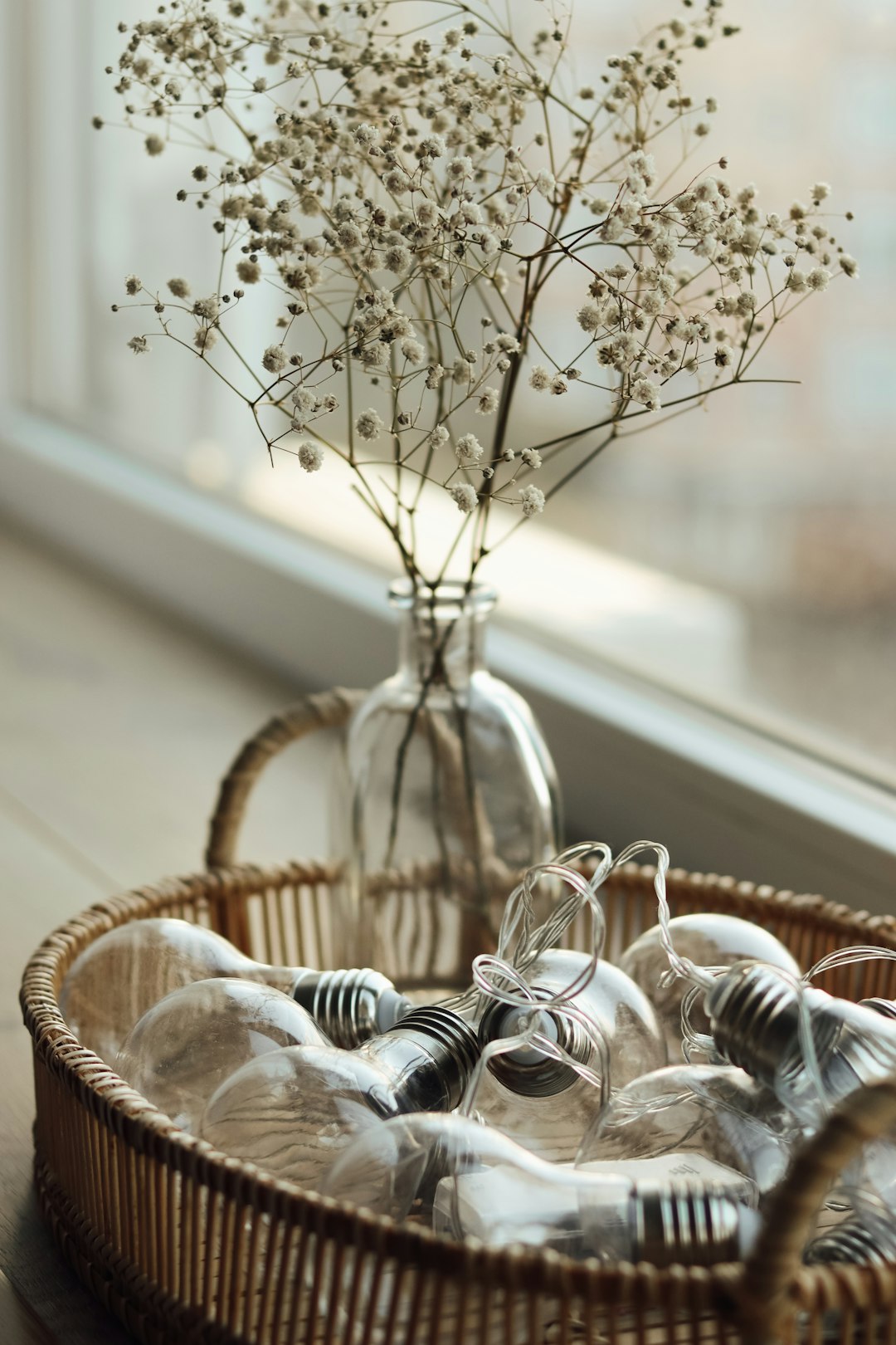 clear glass flower vase on brown woven basket