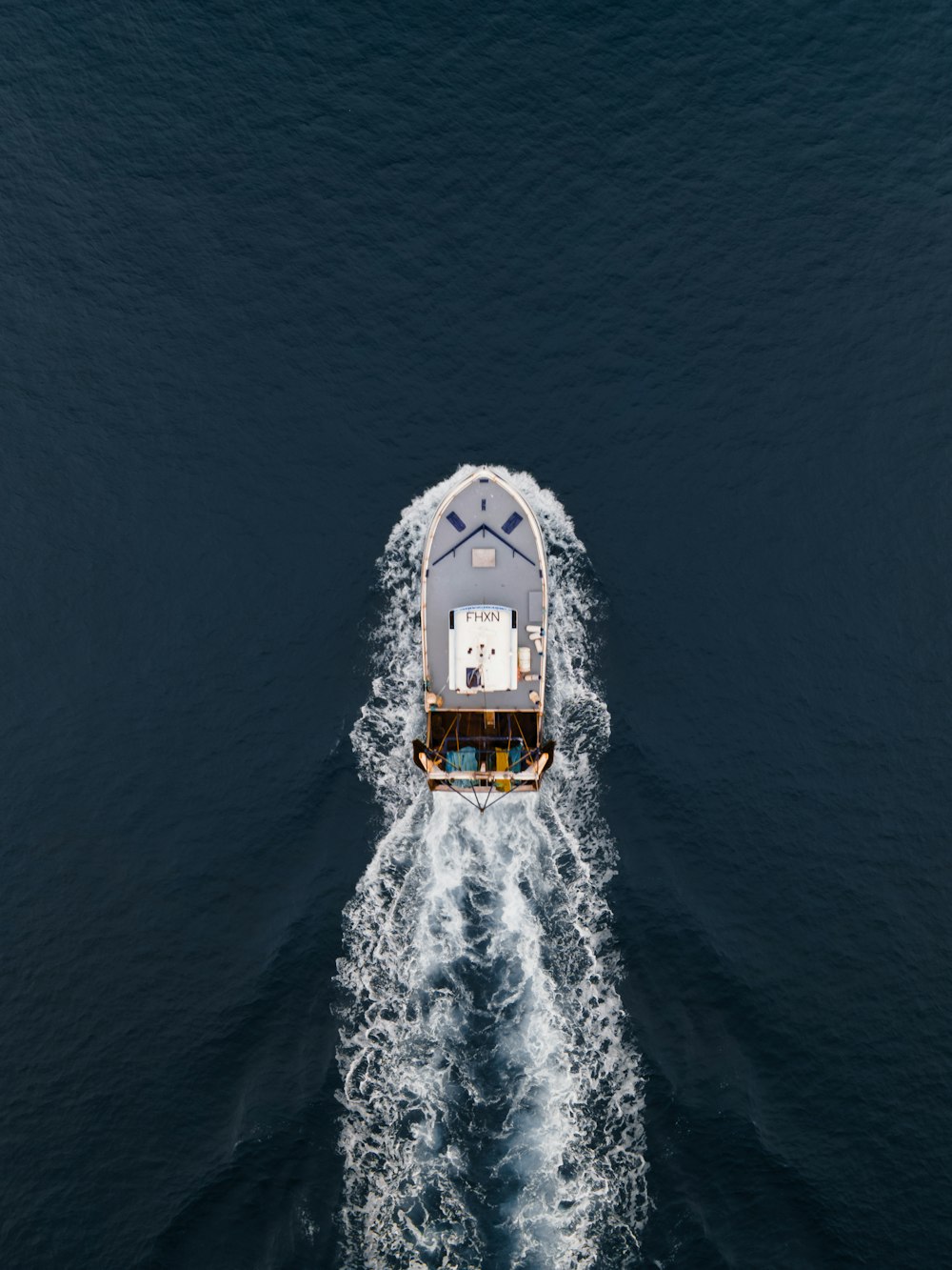 white and black boat on sea during daytime