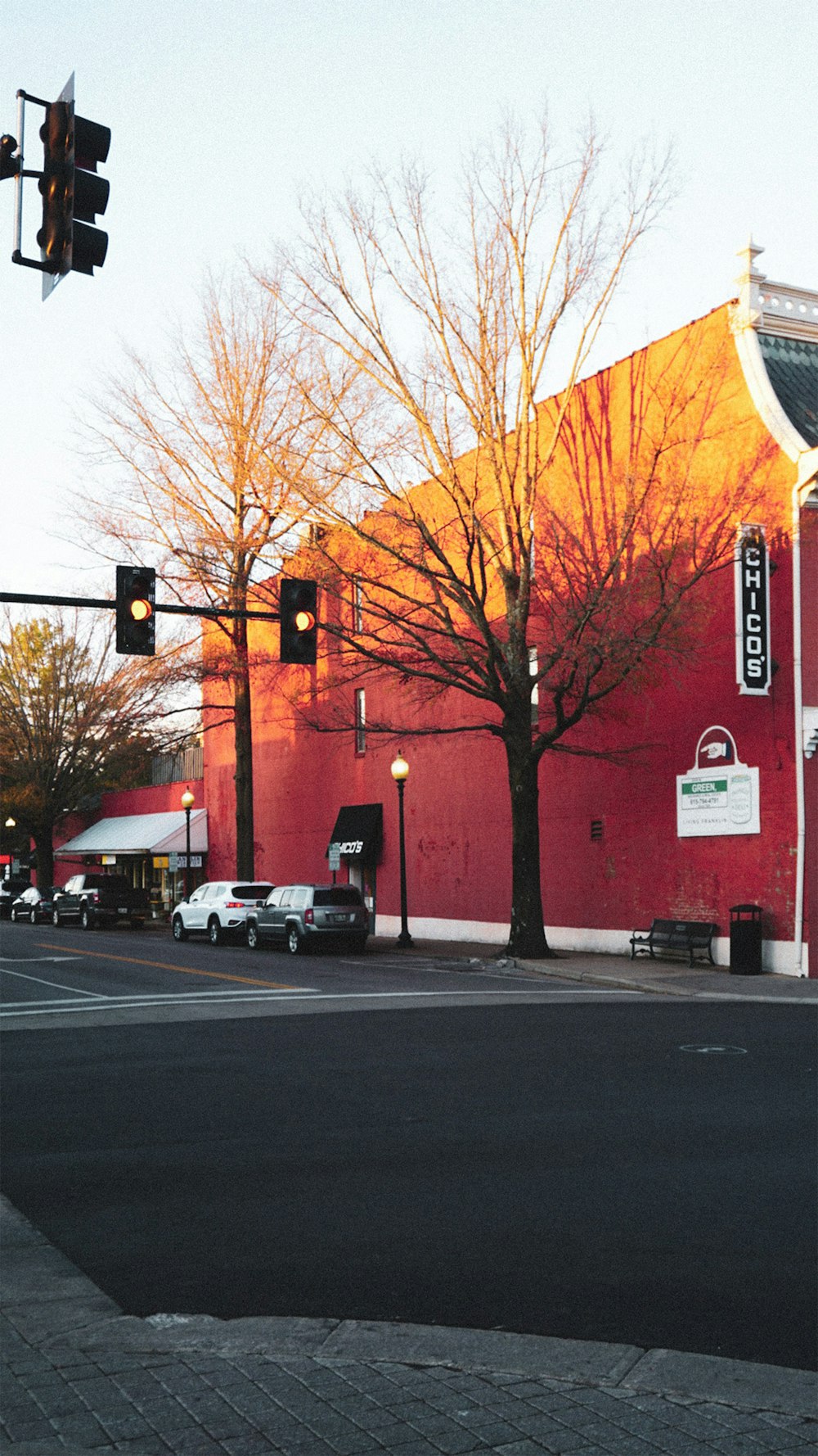 cars parked in front of brown building during daytime