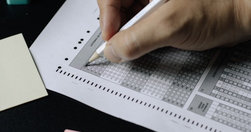 person writing on white paper