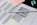 A standardized test answer sheet with multiple-choice bubbles is accompanied by a pencil and a pencil sharpener. Overlapping sheets with filled and unfilled circles indicate test preparation or completion. Colored sticky notes are placed nearby, suggesting organization or note-taking.