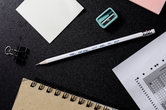 white and black pencil beside white paper