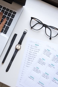 person wearing black round analog watch