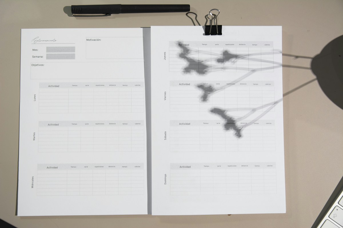 White printer paper with handwritten notes on a brown wooden table, illustrating nonprofit annual report planning ideas.