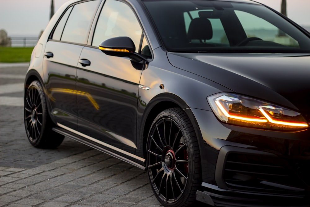 black sedan on gray pavement