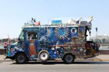 A vibrant art car decorated with lights cruising through the playa.
