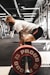 man in white t-shirt and black shorts carrying red and black barbell