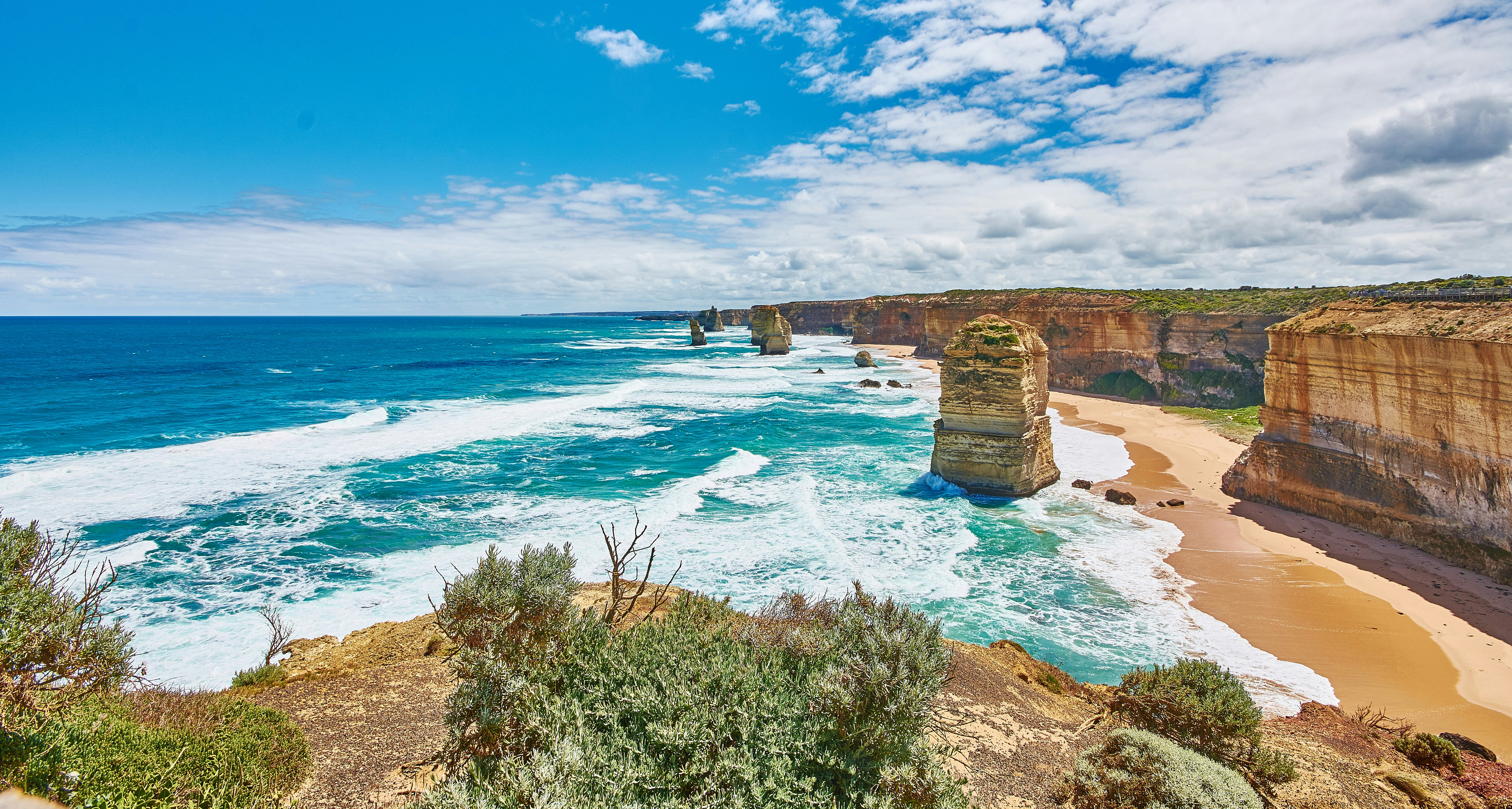 brown rock formation near blue sea under blue sky during daytime