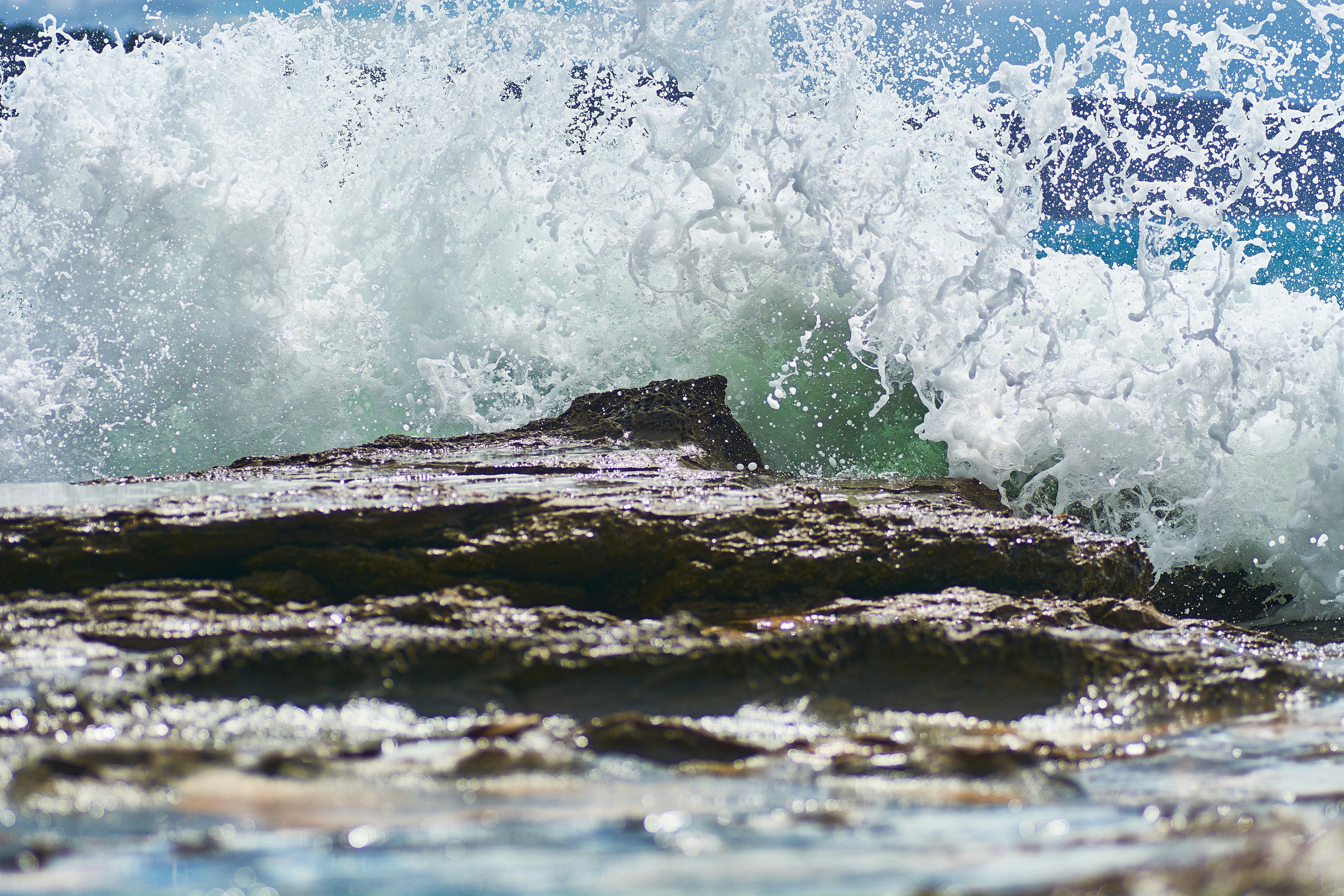 water waves hitting brown rock