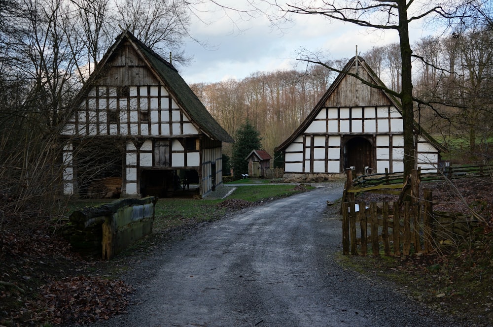 brown wooden house near trees and mountain during daytime