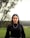 woman in black turtleneck long sleeve shirt standing on green grass field during daytime