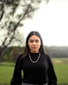 woman in black turtleneck long sleeve shirt standing on green grass field during daytime