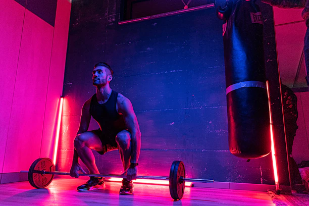 Futuristic gym scene with a focused man training intensely under blue and red neon lights.