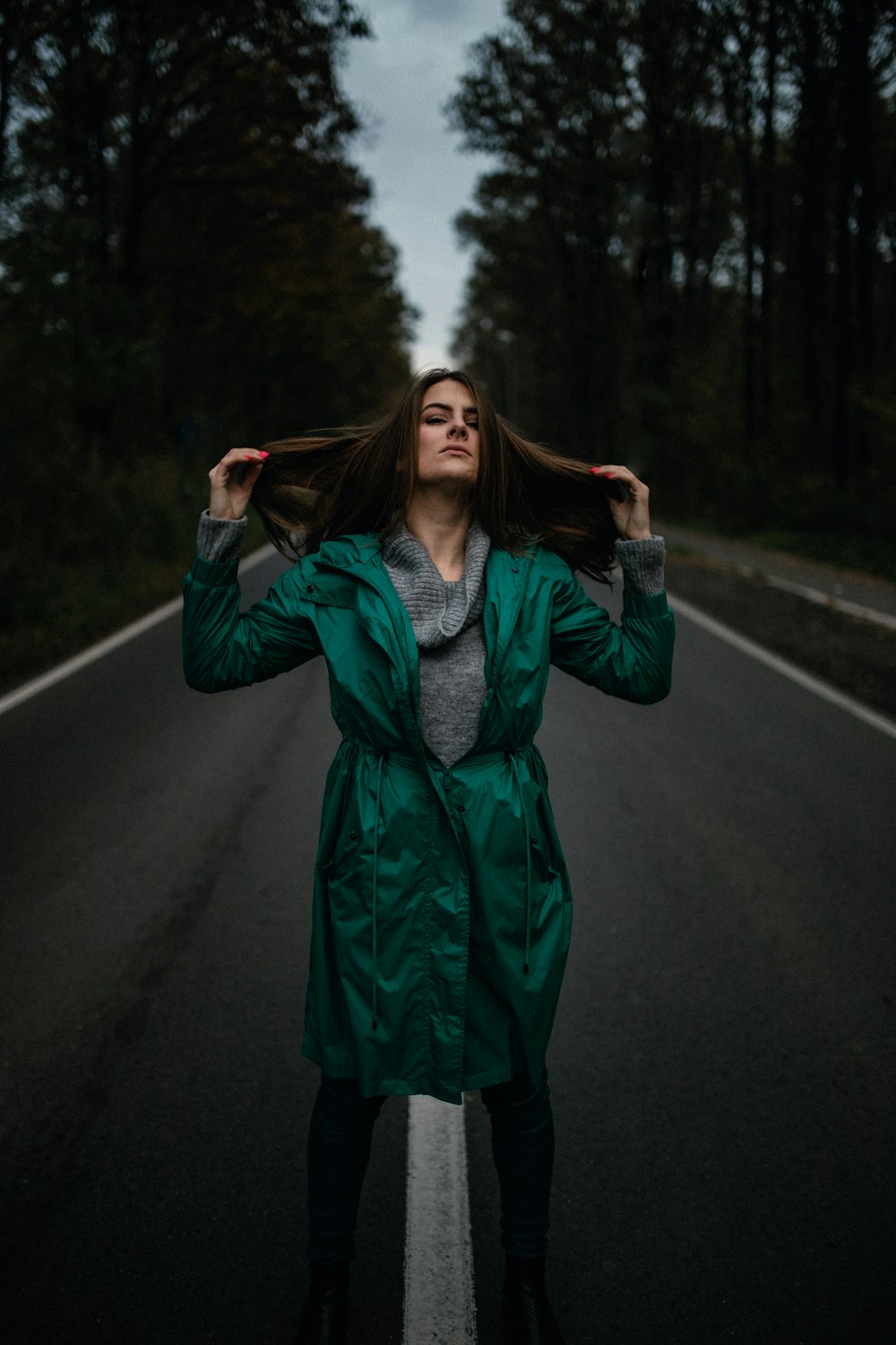 woman in green long sleeve dress standing on road during daytime