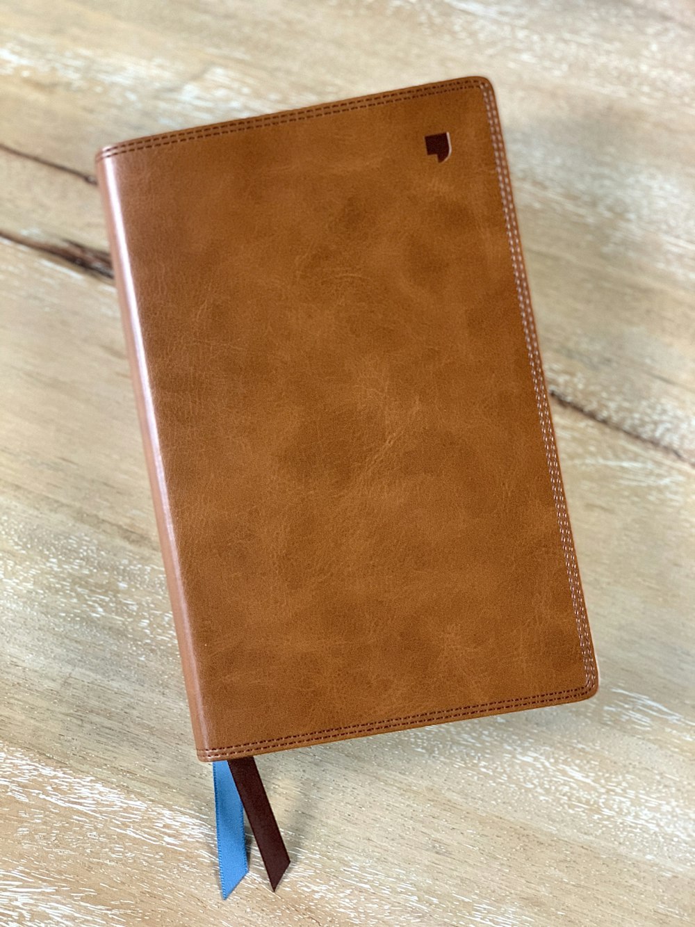 brown leather wallet on brown wooden table