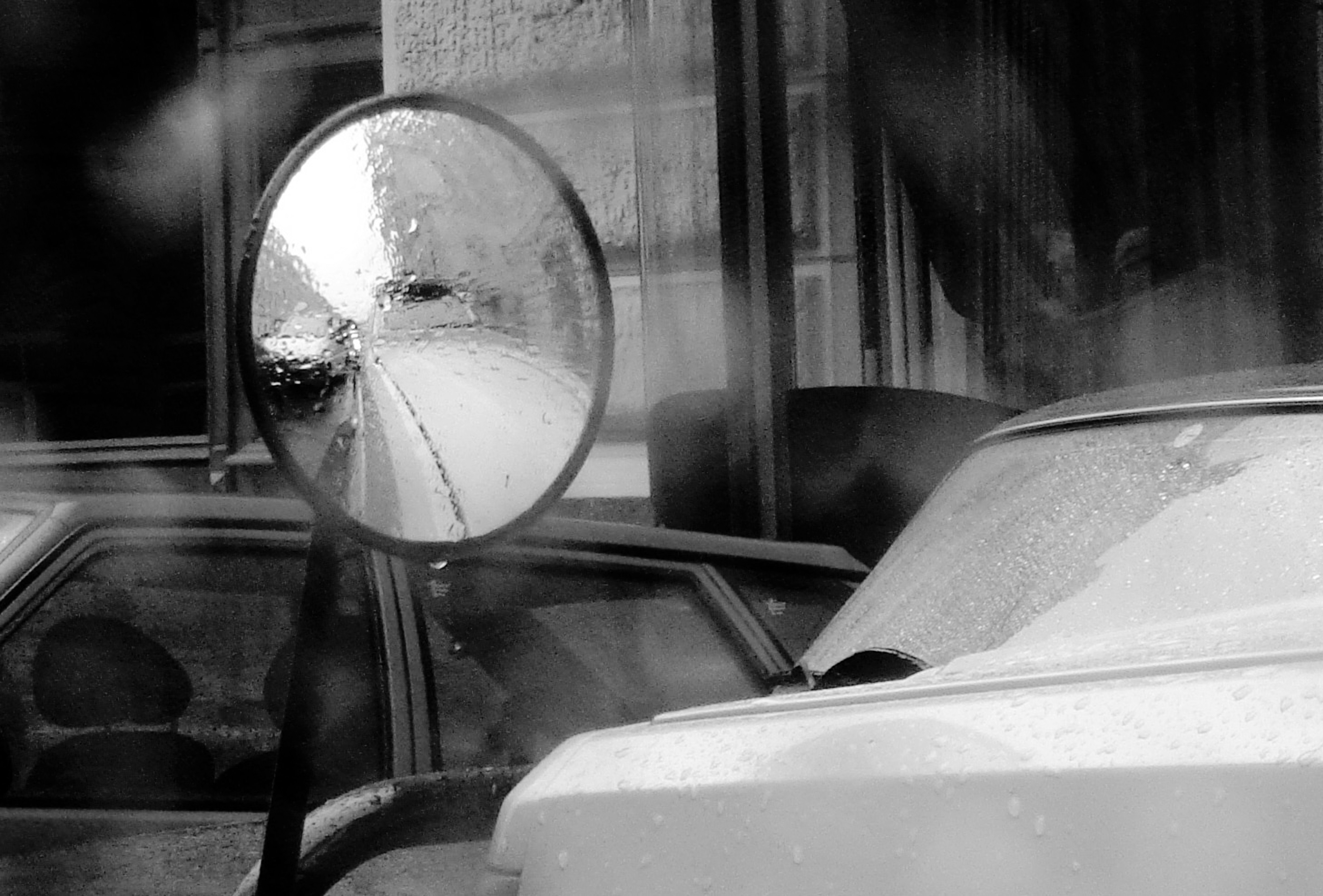 white car in front of glass window