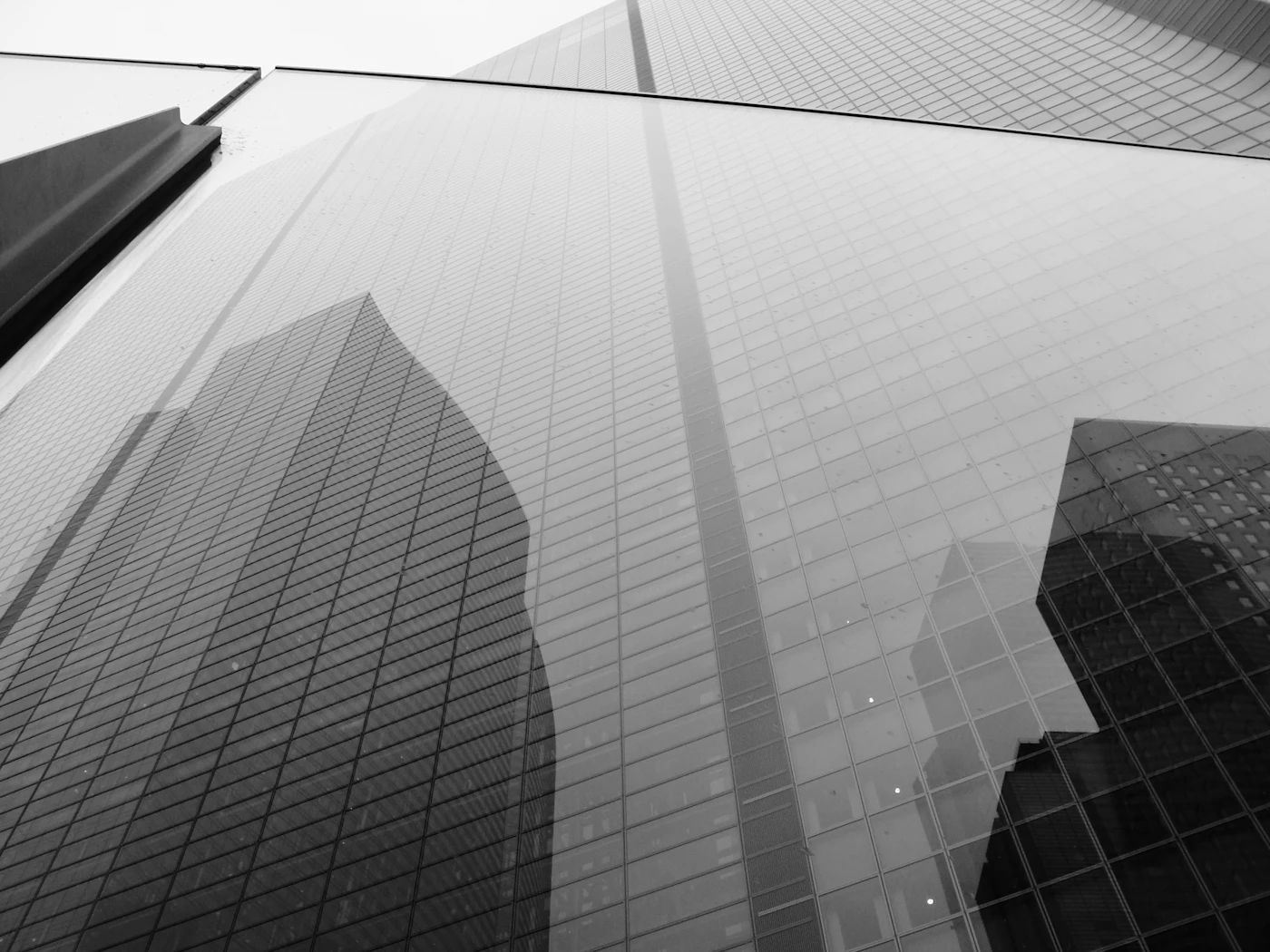 Glass office tower photographed from below