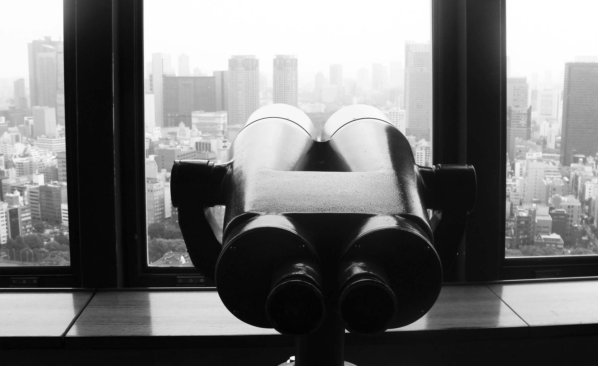 gray binoculars on glass window