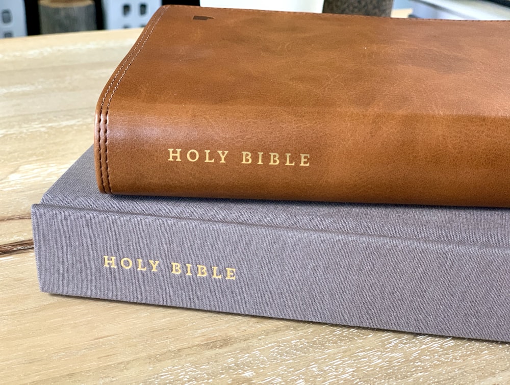 brown leather book on brown wooden table