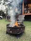 Outdoor fire pit area near the cabin with Adirondack chairs ready for evening gatherings.