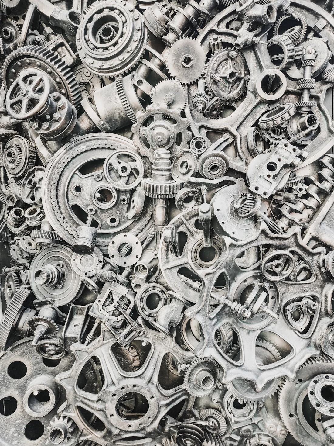 Dense collection of metal gears, cogs and machine parts