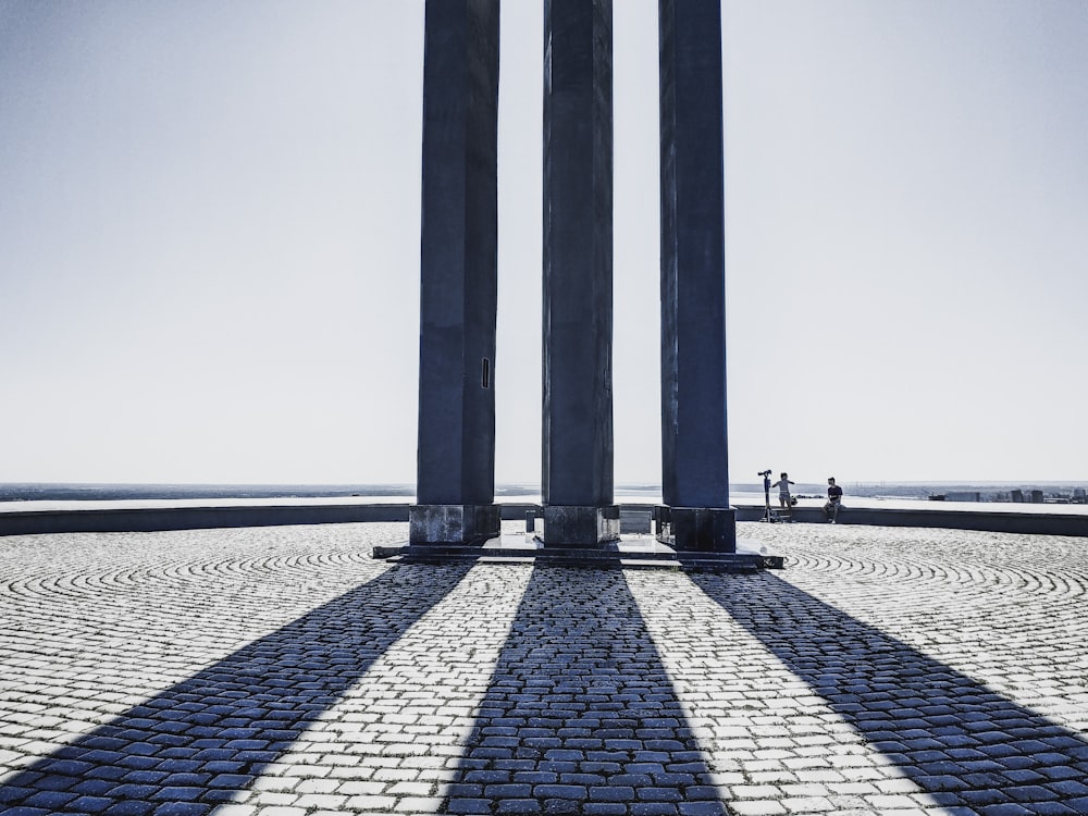 gray concrete posts on gray concrete pavement under white sky during daytime