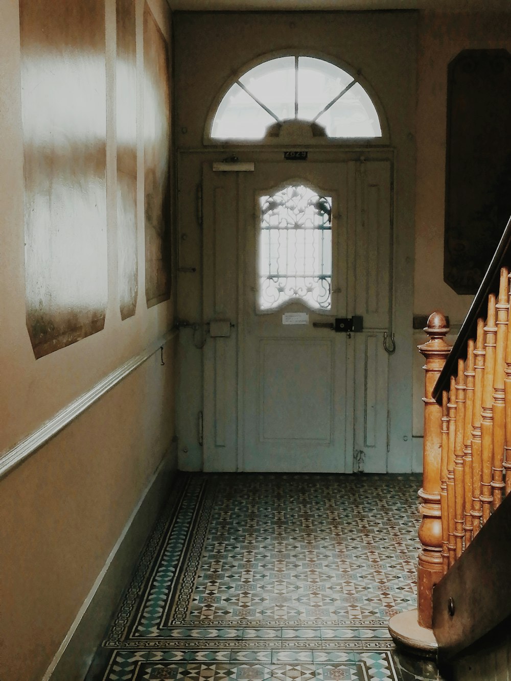 brown wooden staircase near white wooden door