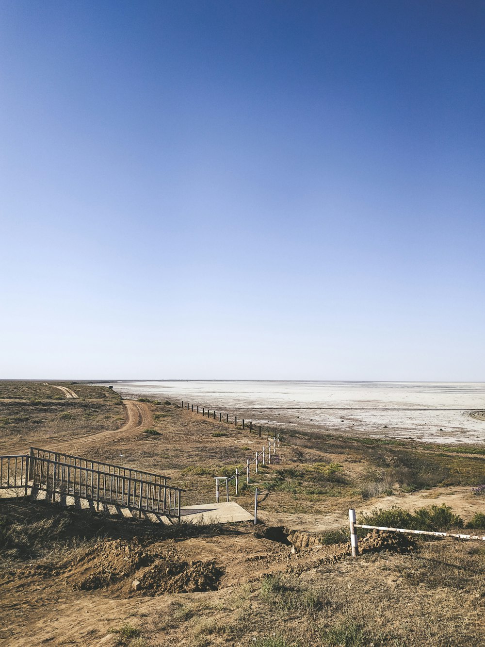 brown wooden fence on seashore during daytime