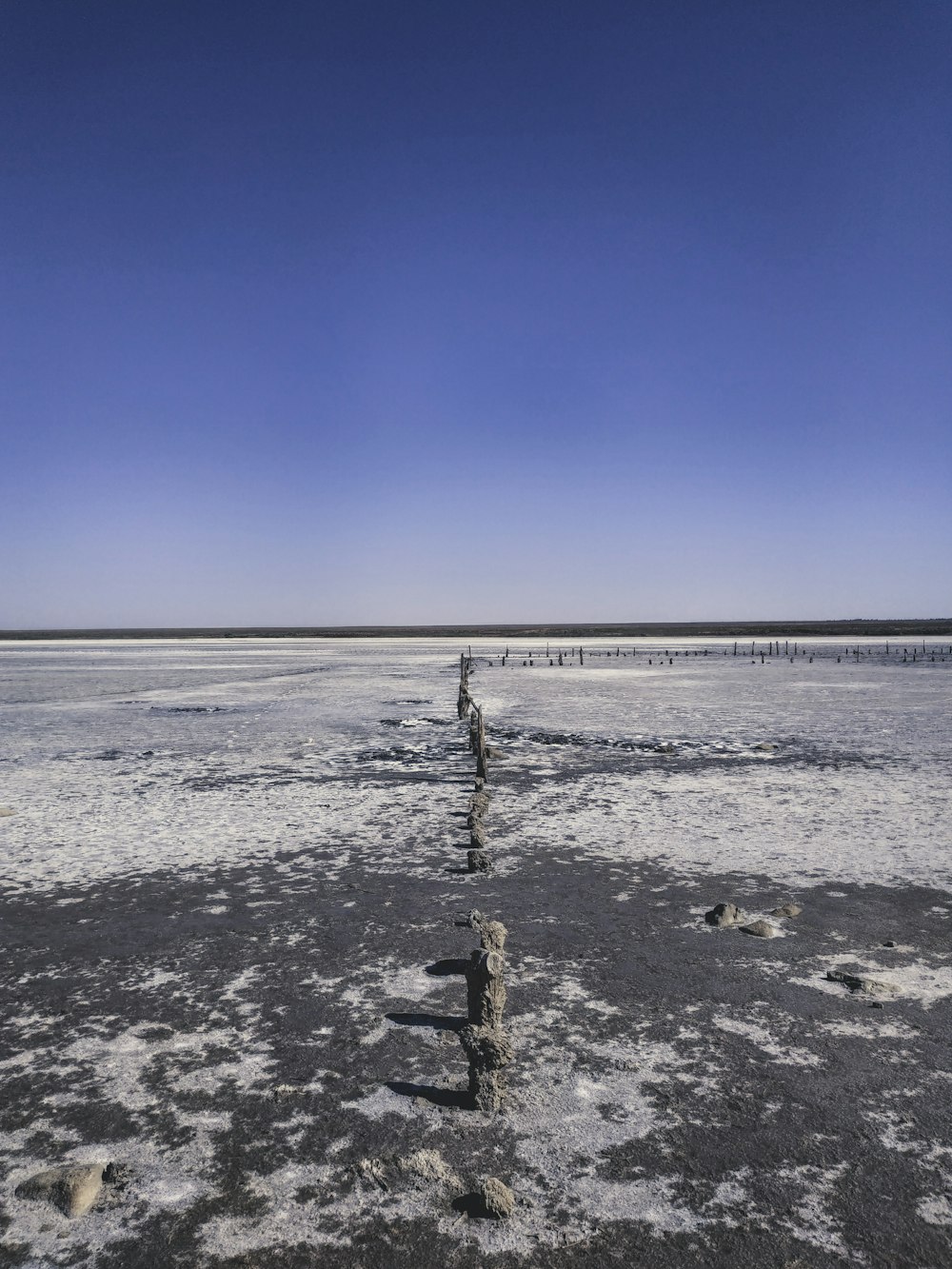 a large body of water sitting next to a sandy beach