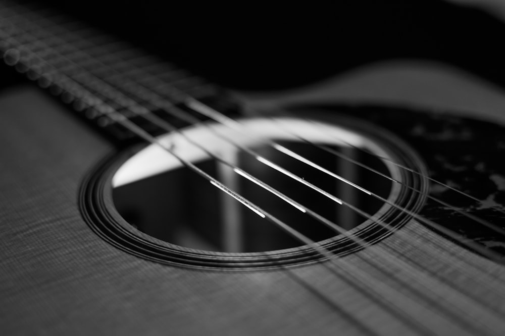 grayscale photo of acoustic guitar