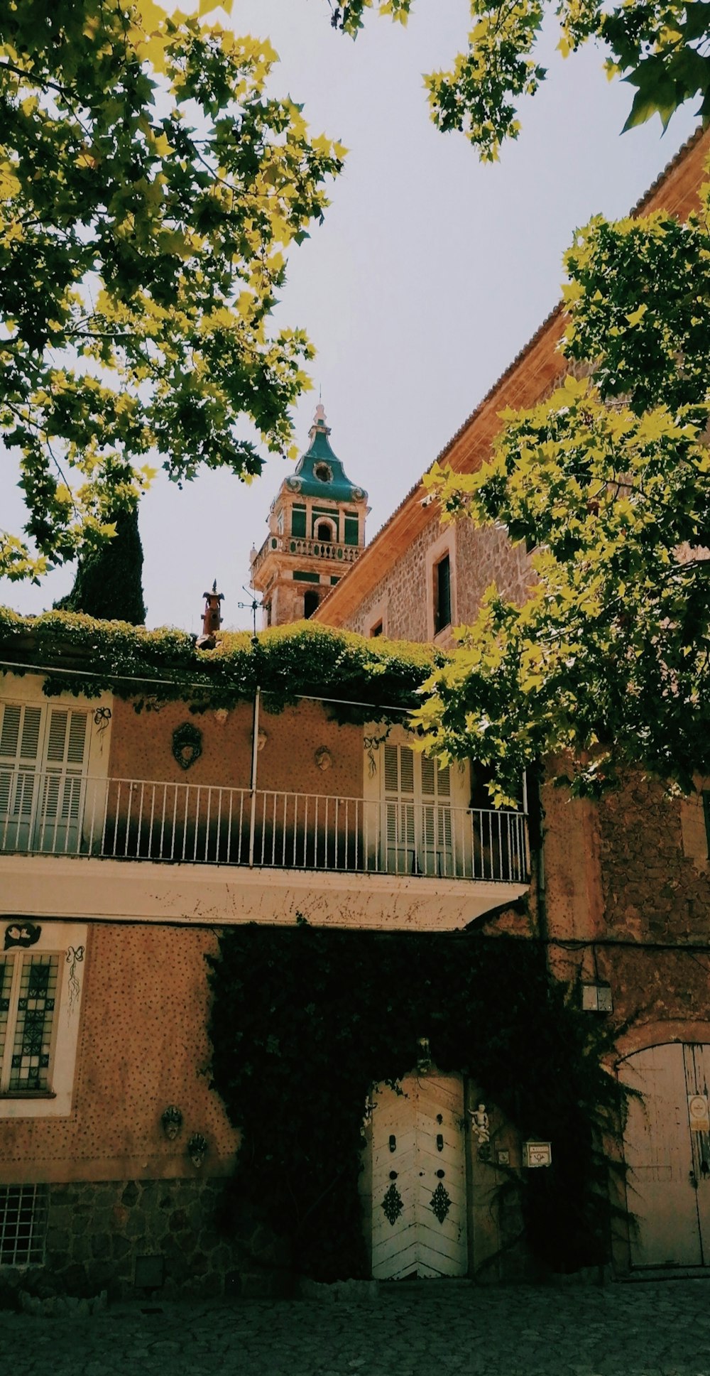 brown brick building with green trees