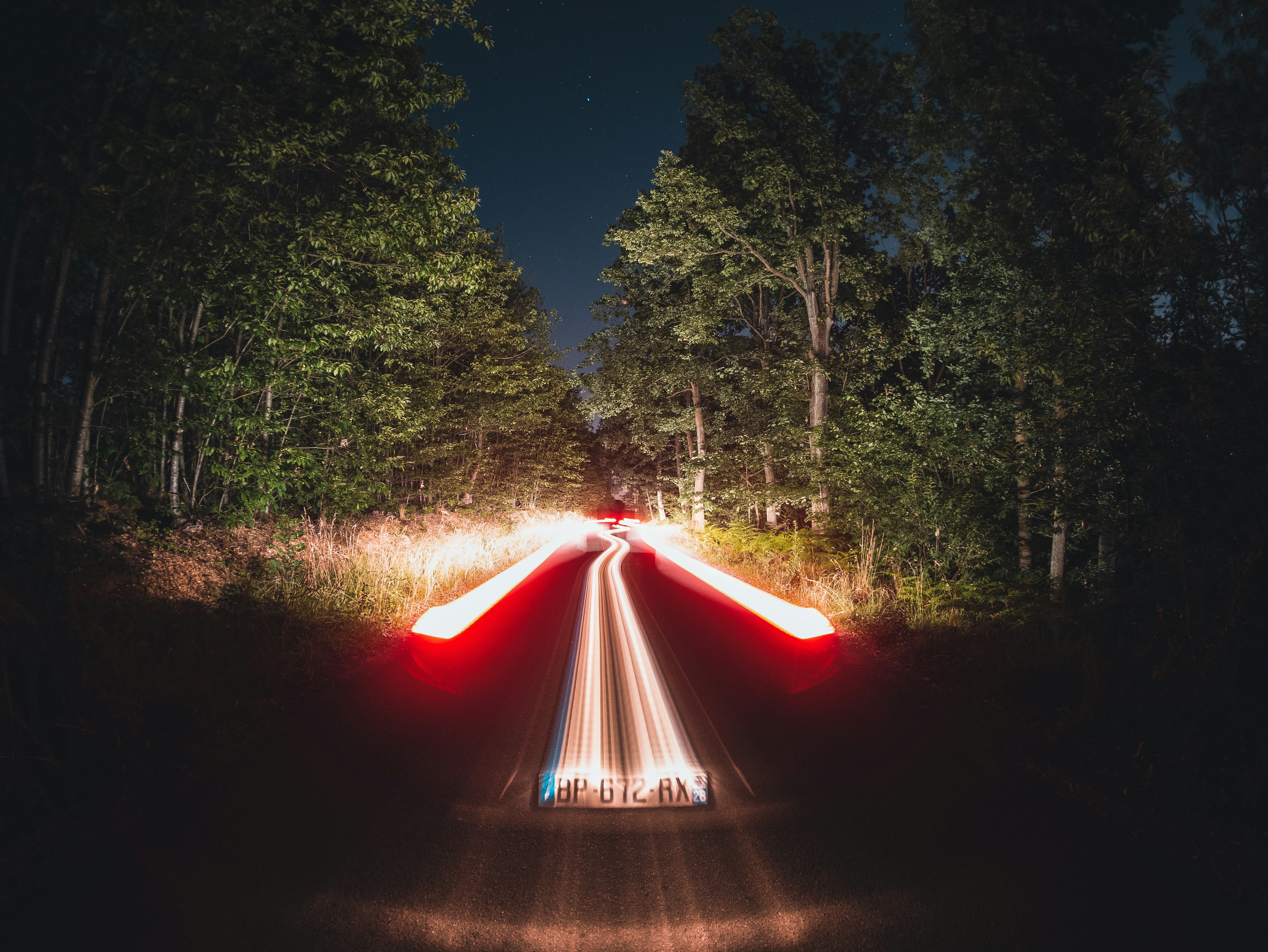 red-and-white-light-on-road-during-night-time